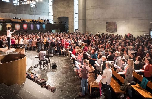 Bei so vielen Gospelsängern im Osten muss Dirigent Thomas Dillenhöfer schon mal auf den Tisch steigen, um den Überblick zu behalten. Foto: Lichtgut/Achim Zweygarth