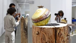 Blickfang in der Alten Kelter: Aus Kunstharz gegossene Früchte  des Künstlers Att Poomtangon thronen auf Holzstämmen. Foto: Patricia Sigerist