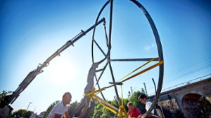 Beim Aufstellen des Kunstwerks ist Teamwork  gefragt:  Der  Durchmesser des Rads misst viereinhalb Meter. Foto: Gottfried Stoppel