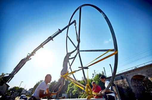 Beim Aufstellen des Kunstwerks ist Teamwork  gefragt:  Der  Durchmesser des Rads misst viereinhalb Meter. Foto: Gottfried Stoppel