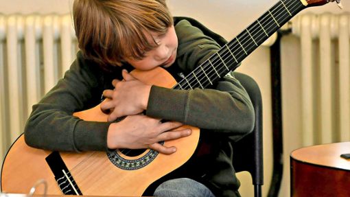 Viele Kinder lernen Gitarre. Alexander  interessiert das Instrument. Foto: imago//Meinert,  Franz