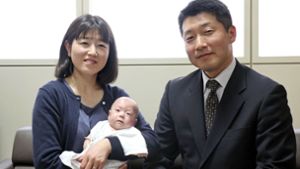 Ryusuke Sekino, der fünf Monate alte Junge, wog bei seiner Geburt gerade mal 258 Gramm. Auf dem Bild liegt das Kind in den Armen seiner Mutter Toshiko Sekino, daneben steht der Vater Kohei Sekino. Foto: Kyodo News/AP