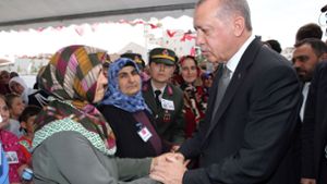 Erdogan spricht bei der Beisetzung einer Mutter und ihres Babys den Hinterbliebenen sein Beileid aus. Foto: AFP