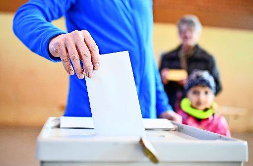 Die Wahlurne ist bei dem neuen Verfahren passé. Die Bürger stimmen am Computer ab. Dabei wird von  Universitäts-Mitarbeitern  auch Hilfe geleistet. Foto: dpa