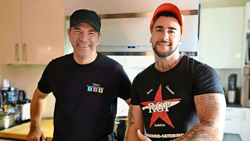 Trikottausch auf Köche-Art: Tino Eggert (rechts) trägt die Farben von Punkrock-Caterer  Oleg Plogstedt, der Hamburger hat ein T-Shirt seines  Freundes und Kollegen angezogen. Foto:  