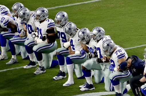 Ein Akt des Protestes gegen Rassismus, aber  auch gegen Donald Trump: die Spieler der Dallas Cowboys knien während des Abspielens der amerikanischen Nationalhymne. Foto: dpa
