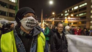 Ein Teilnehmer protestiert am Neckartor mit einem Mundschutz. Foto: Lg/Julian Rettig