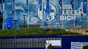 Fans hängen Protest-Plakate vor das Stadion: Seit Wochen ist der Verein in der Krise – nicht nur sportlich. Foto: AFP/SASCHA SCHUERMANN