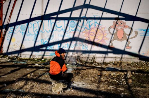 Ein Flüchtling sitzt auf dem Gelände einer ehemaligen Druckfabrik im Westen der Stadt Sid. Foto: AFP/Andrej Isakovic