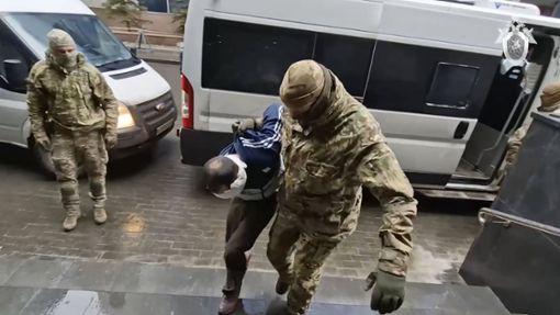 Russische Spezialkräfte führen einen mutmaßlichen IS-Terroristen in Moskau dem Gericht vor. Foto: dpa/Uncredited